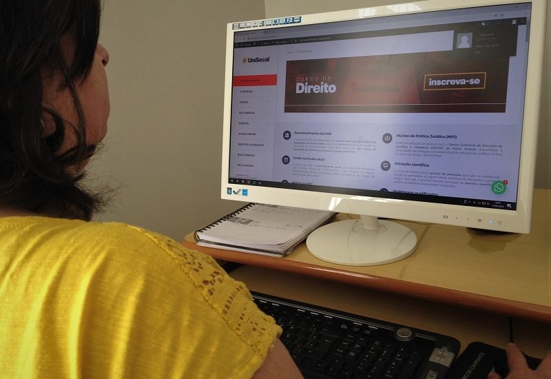 Imagem de uma mulher acessando a página do curso de Direito da UniSecal